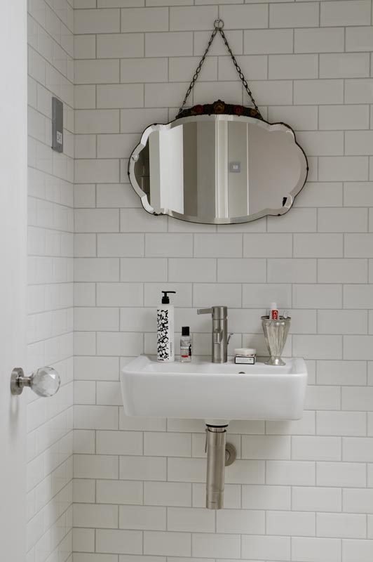 Ванные комнаты выполнены в светлых тонах с использованием белого кафеля. Современный кран отлично сочетается с винтажным зеркалом