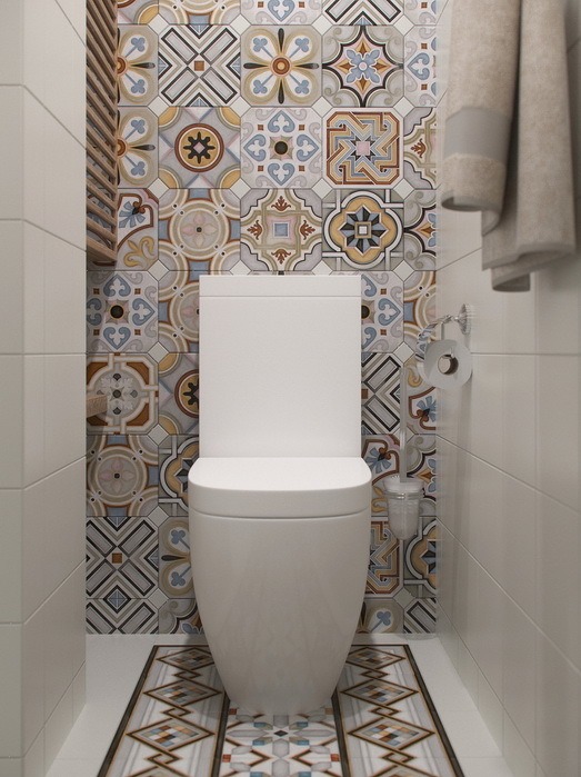 Орнаменты кафельной плитки в туалете образуют ковер на полу и стене