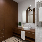 Ретро плитка, брутальная полотенцесушилка и характерный плафон над зеркалом привносят атмосферу лофта в ванную комнату.