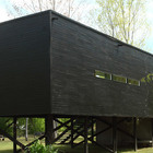 Фасад дома окрашен в черный, как и было задумано архитекторами при постройке дома.
