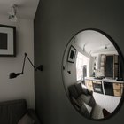 Выпуклое круглое зеркало служит украшением этой жилой гостиной.