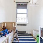 С появлением второго ребенка, родители реконструировали небольшую комнату прилегающую к кухне для старшего мальчика. Детская получилась светлой с простым скандинавским интерьером.